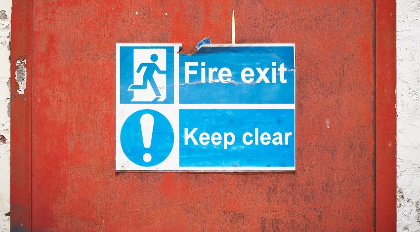 Notice on a door saying 'Fire exit - Keep clear' 