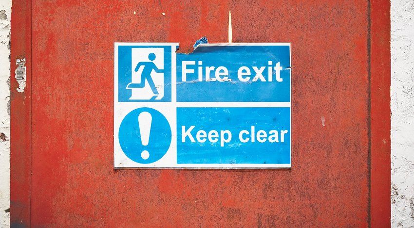 Notice on a door saying 'Fire exit - Keep clear'